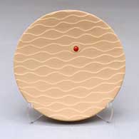 A small salmon plate with an inlaid stone and a Drifting Sands textured surface
 by Preston Duwyenie of Hopi