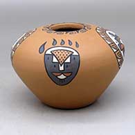 A polychrome jar decorated with a four-panel bear paw, rain cloud and geometric design
 by Minnie Vigil of Santa Clara