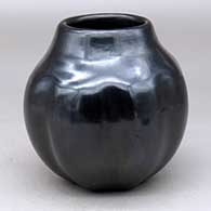 A black melon jar with 8 carved ribs
 by Legoria Tafoya of Santa Clara