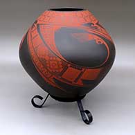 A red on brown jar decorated with a three-panel bird element and geometric design
 by Noe Quezada of Mata Ortiz and Casas Grandes