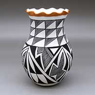 A polychrome vase with a pie crust rim and decorated with a four-panel geometric design
 by Eva Histia of Acoma