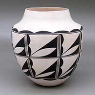 A black on white jar with a short neck and decorated with an eight panel cloud formation geometric design
 by Marquis Lente of Laguna