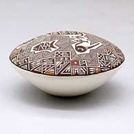 A polychrome seed pot decorated above the shoulder with a crane, fish, fineline and geometric design, click or tap to see a larger version