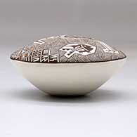 A polychrome seed pot decorated above the shoulder with a crane, fish, fineline and geometric design, click or tap to see a larger version
