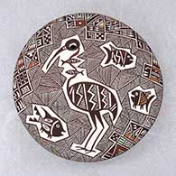 A polychrome seed pot decorated above the shoulder with a crane, fish, fineline and geometric design
 by Rebecca Lucario of Acoma