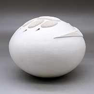 A white seed pot decorated with an applique ribbon and bear paw with cutouts for the claws, click or tap to see a larger version