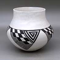 A black on white jar decorated with a four panel angular spiral, checkerboard, fineline and geometric design
 by Stella Shutiva of Acoma