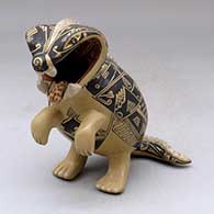 A standing polychrome dragon figure
 by Manuel Rodriguez of Mata Ortiz and Casas Grandes