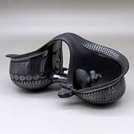 A black on black double bowl with a serpent rim and mice inside, decorated around the body with a geometric design
 by Nicolas Ortiz of Mata Ortiz and Casas Grandes