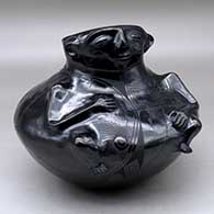 A black on black shaman jar decorated with a flowing geometric design
 by Lydia Quezada of Mata Ortiz and Casas Grandes