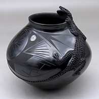 A black on black jar decorated with a corrugated lizard applique and geometric design
 by Rito Talavera of Mata Ortiz and Casas Grandes