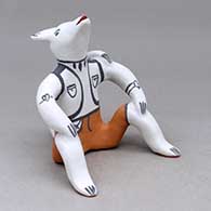 A polychrome sitting Singing Coyote figure
 by Martha Arquero of Cochiti