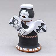 A standing Singing Angel storyteller figure holding one baby
 by Martha Arquero of Cochiti