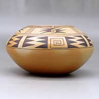 A black on brown jar decorated with a geometric design above the shoulder and fire clouds, click or tap to see a larger version