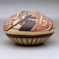 A polychrome jar carved and painted with a long hair and turtle kachina design, click or tap to see a larger version