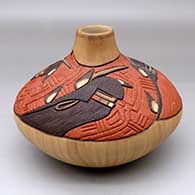 A polychrome jar decorated with a carved, sgraffito and painted rendition of the Long Hair Kachinas, feathers and geometric design
 by Elvira Nampeyo of Hopi