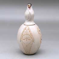 A lidded jar decorated with a sgraffito katsina face and geometric design plus 10 inlaid stones
 by Patricia Daubs of Jemez