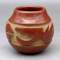 A red jar carved with a stylized avanyu design around the shoulder
 by Mary Cain of Santa Clara