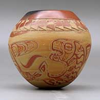 A polychrome jar decorated with a lightly carved and slipped Northwest Coast and geometric design, click or tap to see a larger version