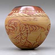 A polychrome jar decorated with a lightly carved and slipped Northwest Coast and geometric design, click or tap to see a larger version