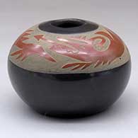 A black seed pot decorated with a sgraffito avanyu design in a wide band of sienna below the opening
 by Camilio Tafoya of Santa Clara