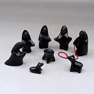 An eight piece black on black December 24th Nativity set with a string of red heishi beads
 by Autumn Borts of Santa Clara