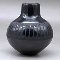 A black on black jar with a raised rim and decorated around the shoulder with a band of feathers design, click or tap to see a larger version