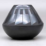 A black on black jar decorated with a ring of feathers design above the shoulder, click or tap to see a larger version