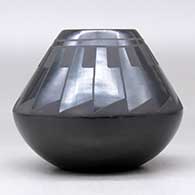 A black on black jar decorated with a ring of feathers design above the shoulder, click or tap to see a larger version