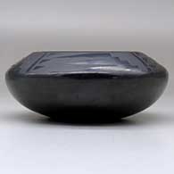 A small black on black bowl decorated with a four-panel bat wing and geometric design above the shoulder, click or tap to see a larger version
