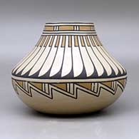 A polychrome low shouldered jar  decorated with a feather and geometric design, click or tap to see a larger version