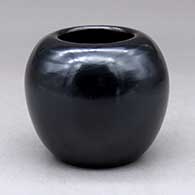 A small plain polished black jar
 by Adam and Santana Martinez of San Ildefonso