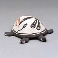 Click for a larger view A polychrome turtle figure decorated with a dragonfly, tadpole and geometric design
 by Carlos Laate of Zuni