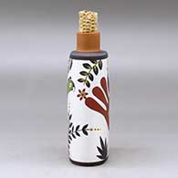 A polychrome flask with a corn cob stopper and decorated with a parrot, plant and geometric design, click or tap to see a larger version