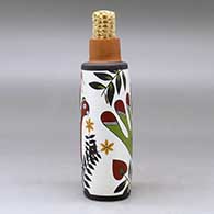 A polychrome flask with a corn cob stopper and decorated with a parrot, plant and geometric design, click or tap to see a larger version