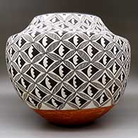 A large polychrome jar decorated with pumpkin seed snowflake, fine line and geometric design
 by Marie Z Chino of Acoma