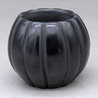 A small black melon bowl carved with 12 ribs
 by Marvin and Frances Martinez of San Ildefonso