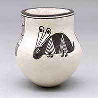 A small black on white jar decorated with a four-panel Mimbres rabbit and geometric design
 by Dolores Lewis of Acoma