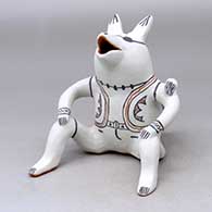 A sitting, singing coyote figure
 by Martha Arquero of Cochiti