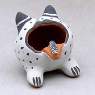 A sitting frog figure with a caterpillar on its tongue
 by Martha Arquero of Cochiti