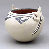 A polychrome bowl decorated with a cloud formation geometric design and a pair of lizard appliques above the shoulder
 by Unknown of Cochiti