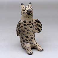 A black on white sitting bird figure
 by Unknown of Cochiti