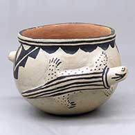 A polychrome bowl decorated with a pair of lizard appliques and a geometric design
 by Unknown of Cochiti