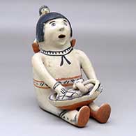 A sitting grandmother storyteller figure with two children
 by Unknown of Cochiti