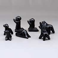 A miniature seven-piece matte and polished black Nativity set, click or tap to see a larger version