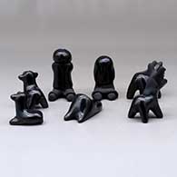 A miniature seven-piece matte and polished black Nativity set, click or tap to see a larger version