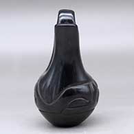A small black wedding vase decorated with a carved stylized avanyu around the body, click or tap to see a larger version