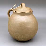 A lidded golden micaceous jar with a handle
 by Virginia Romero of Taos