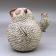 A polychrome owl figure with a chick sitting on its tail, click or tap to see a larger version
