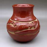 A red water jar with a recurved neck and carved around the shoulder with an avanyu design
 by Jennie Trammel of Santa Clara